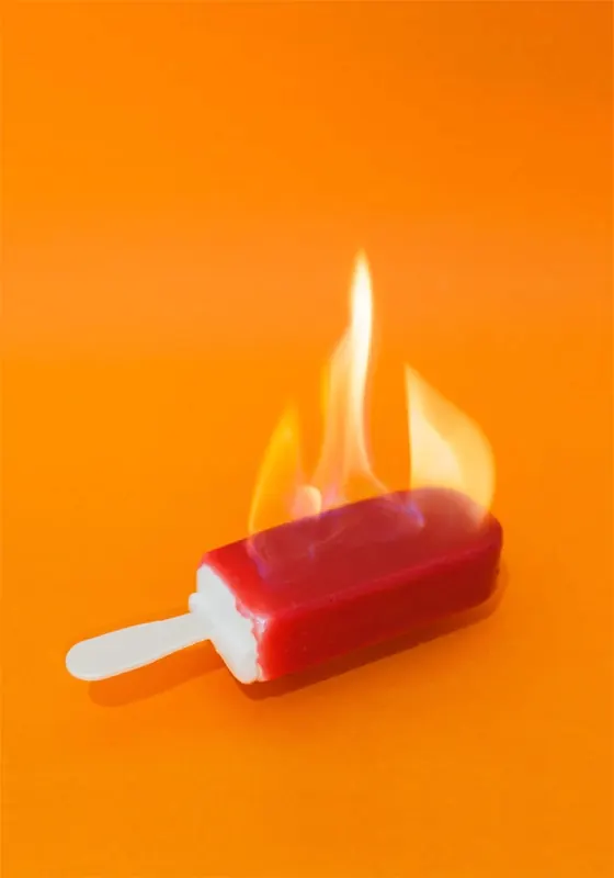 Flaming Popsicle on Orange Background, playful, photographic, vibrant