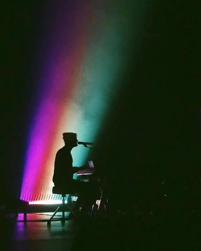 Silhouette Musician with Rainbow Light Beam, dark-mode, photographic, dark