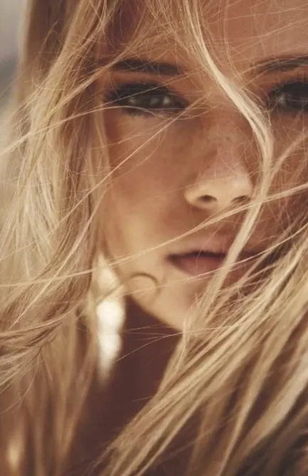 Close-up Portrait of a Woman with Blonde Hair, photographic, luxury, warm