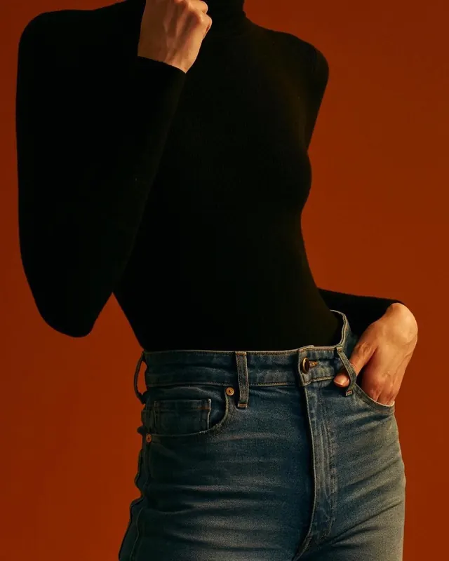 Woman in Black Sweater and Jeans, minimal, photographic, high-contrast