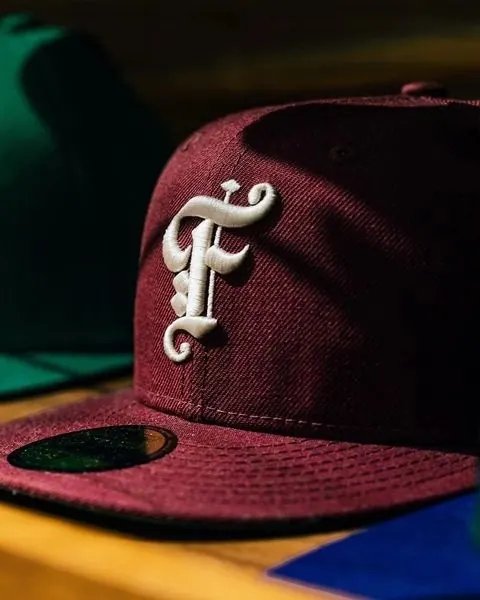 Embroidered Letter Logo on Cap, photographic, minimal, dark