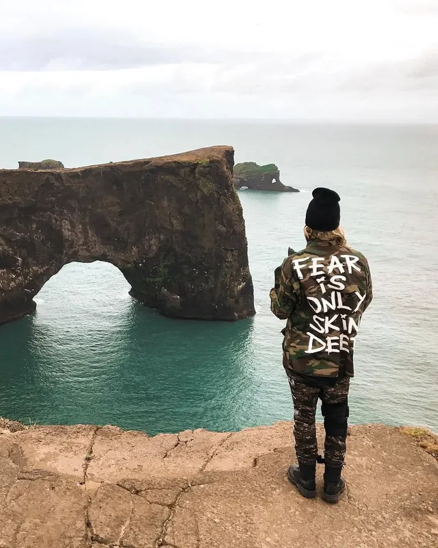 Person Standing on Cliff Edge with Coastal Scenery, photographic, organic, cool