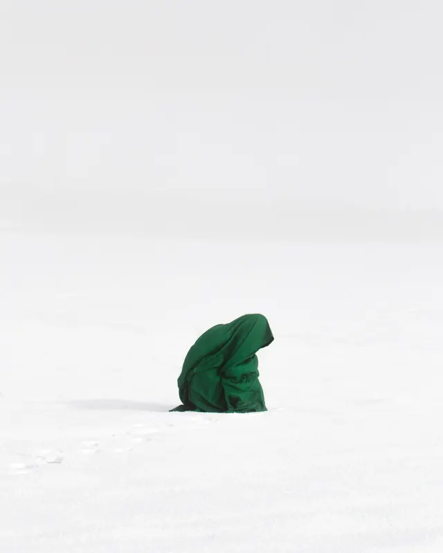 Green Fabric Sculpture in Snow, minimal, photographic, high-contrast