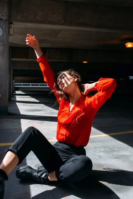 Man in Orange Shirt Stretching, photographic, vibrant
