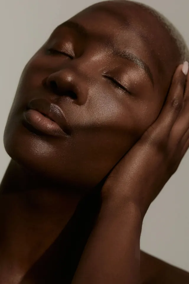 Close-up Portrait of a Person with Glowing Skin, photographic, luxury, warm