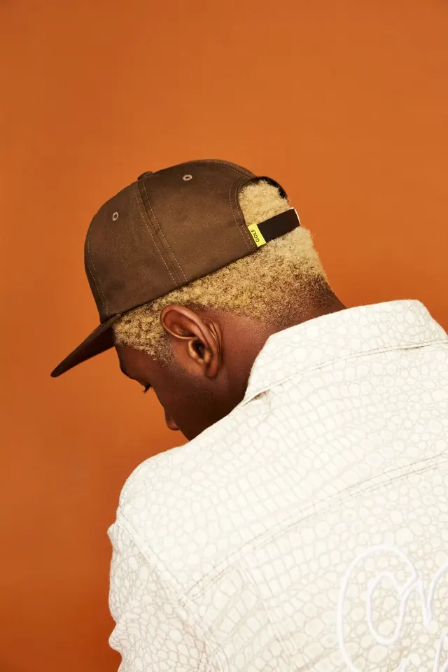 Man in Brown Cap and White Sweater, photographic, minimal, warm
