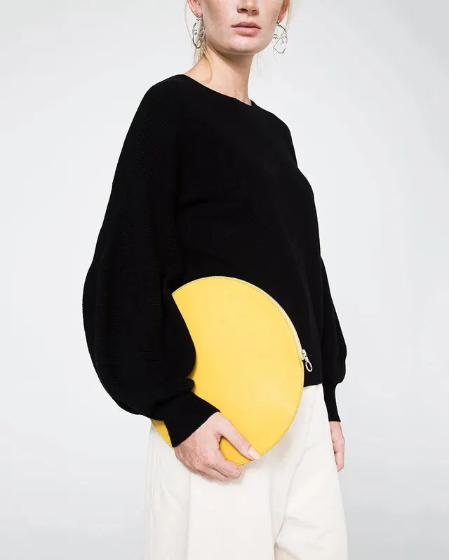 Woman in Black Sweater with Yellow Graphic, minimal, photographic, high-contrast