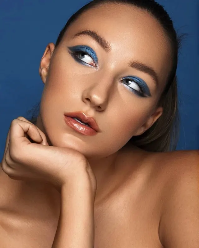 Close-up Portrait of a Woman with Blue Eye Makeup, photographic, luxury, vibrant