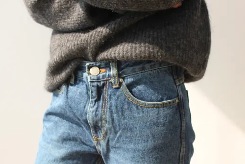 Close-up of Denim Jeans and Knit Sweater, photographic, minimal, muted