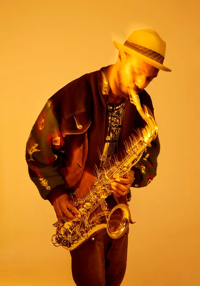 Musician with Saxophone in Warm Lighting, photographic, warm