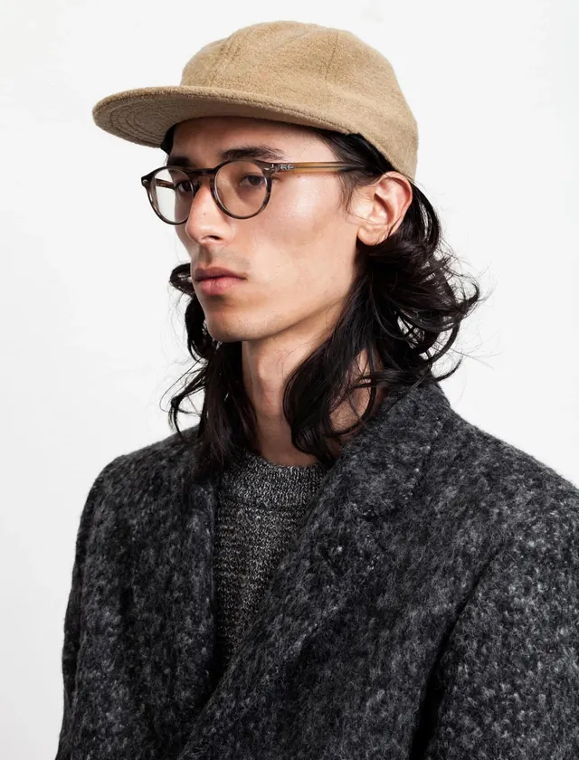 Portrait of a Man in a Beanie and Glasses, photographic, minimal, muted