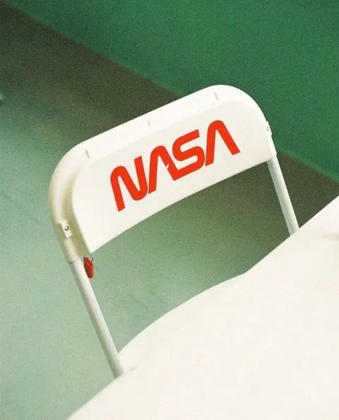 NASA Logo on White Chair, minimal, corporate-clean, high-contrast