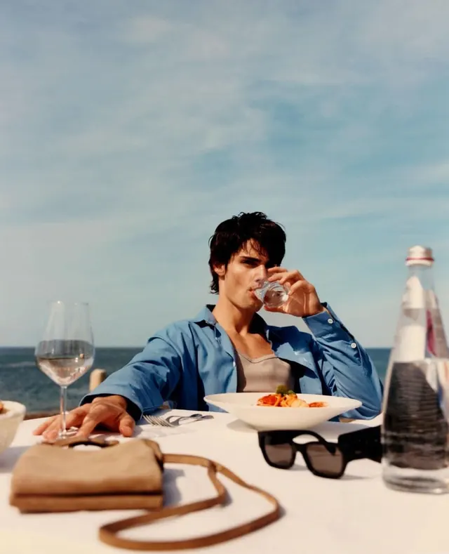 Man Enjoying Wine on a Beach, photographic, luxury, light