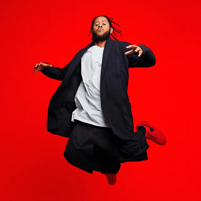 Man in Streetwear Jumping Against Red Background, photographic, vibrant