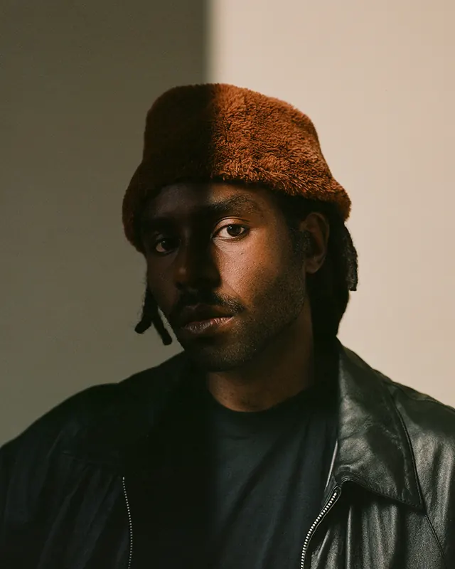 Portrait of a Man in a Beanie, photographic, minimal, dark