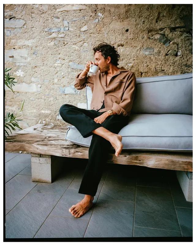 Man Sitting on Bench in Urban Setting, photographic, organic, earthy