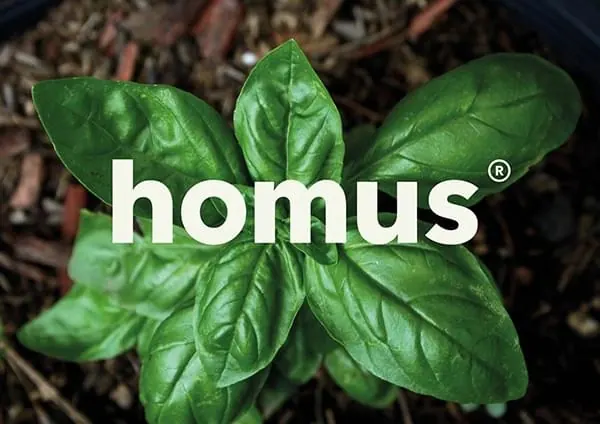 homus logo on green leaves, organic, photographic, vibrant