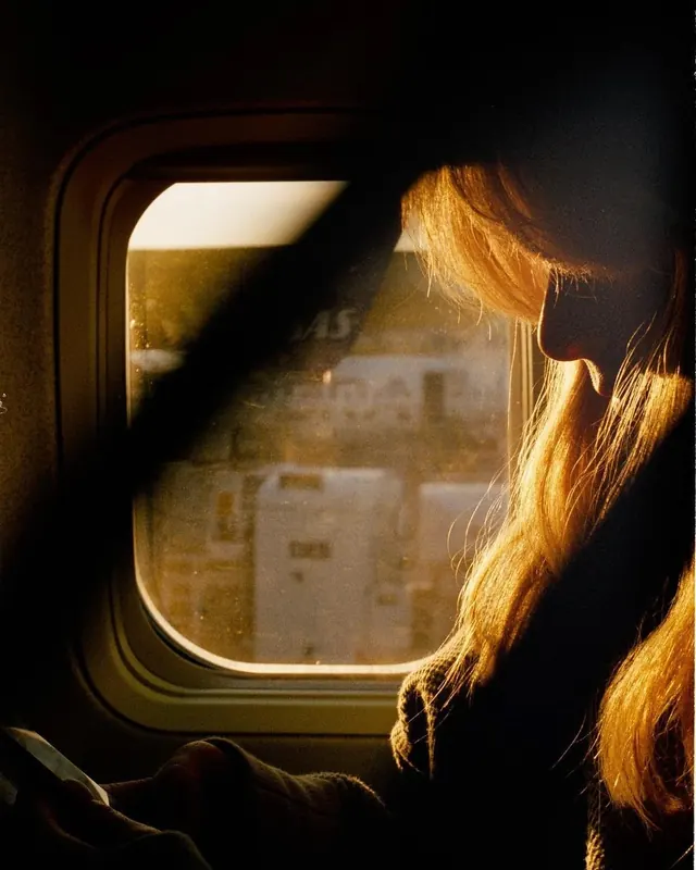 Woman Looking Out Train Window, photographic, organic, warm