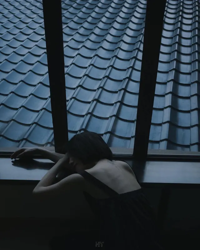 Woman Looking at Tiled Roof, photographic, minimal, dark