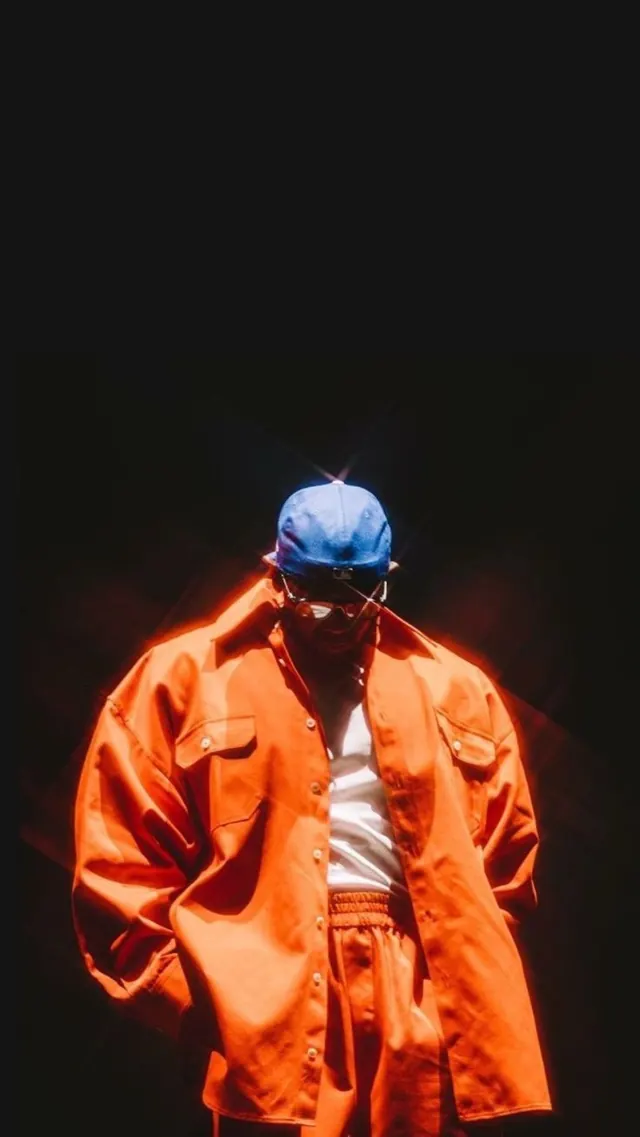 Person in Orange Jacket and Blue Helmet, photographic, dark-mode, high-contrast