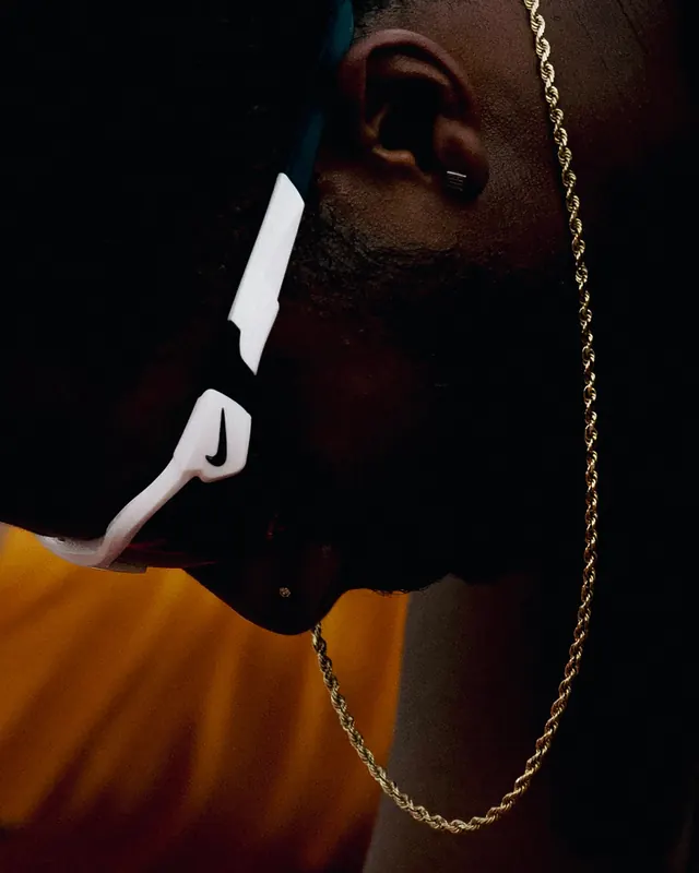 Close-up Portrait with Gold Chain, dark-mode, photographic, dark