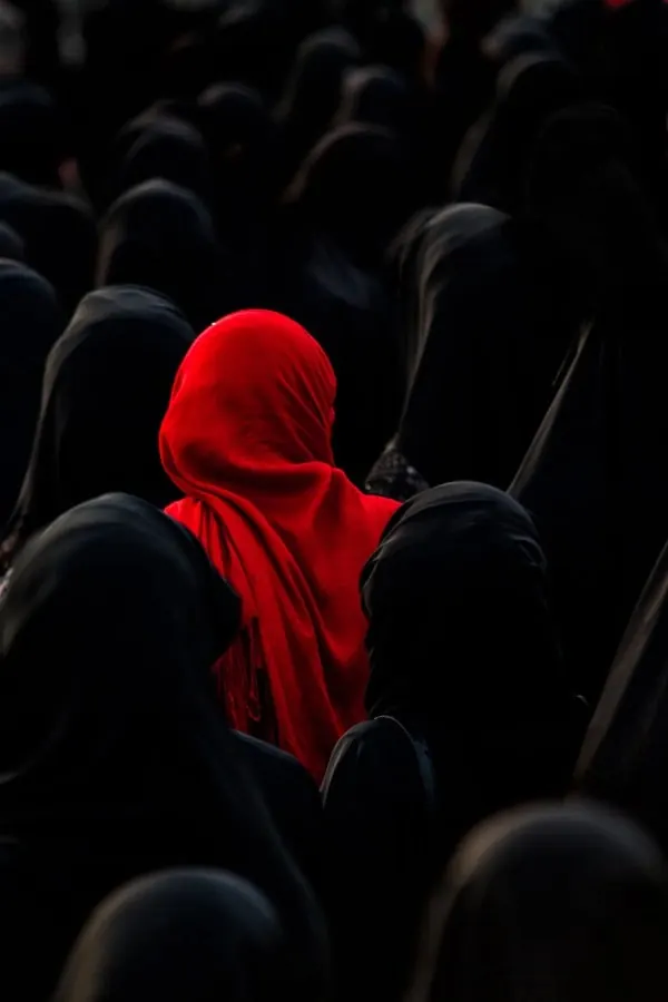 Red Hooded Figure in Crowd, photographic, minimal, dark