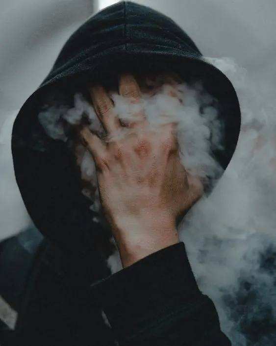 Person in Hoodie with Smoke, dark-mode, photographic, dark