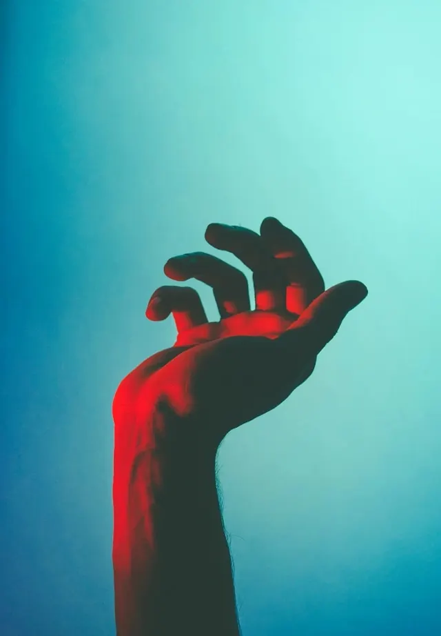 Red Hand Silhouette against Blue Background, minimal, abstract, vibrant