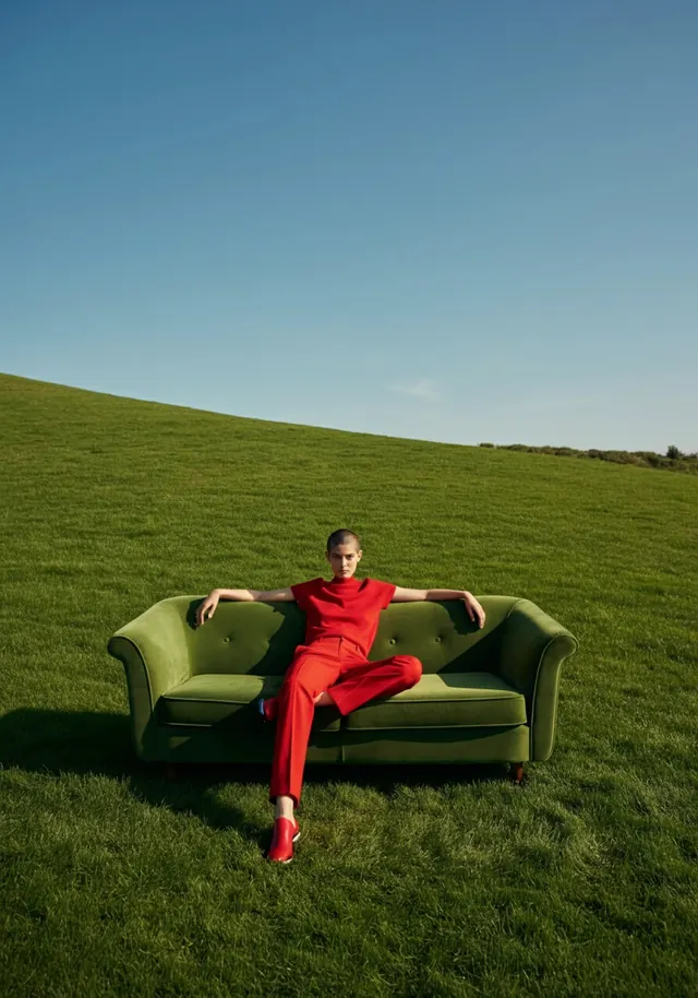 Woman in Red on Green Hill, minimal, photographic, vibrant