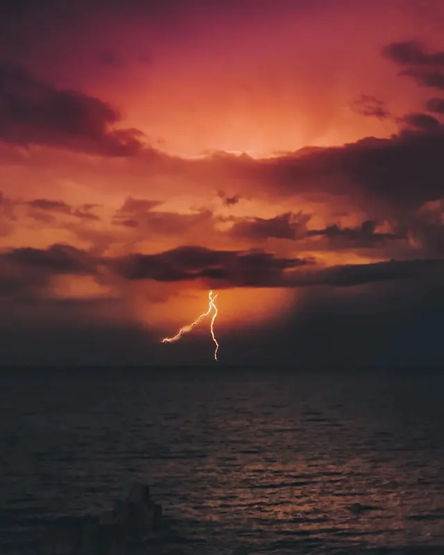 Lightning Strike Over Ocean at Sunset, photographic, abstract, warm