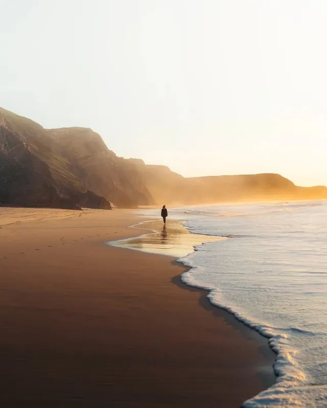 Lone Figure on a Misty Beach, minimal, photographic, muted