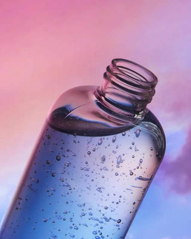 Blue Bubble Bottle Render, glassmorphism, gradient-heavy, vibrant