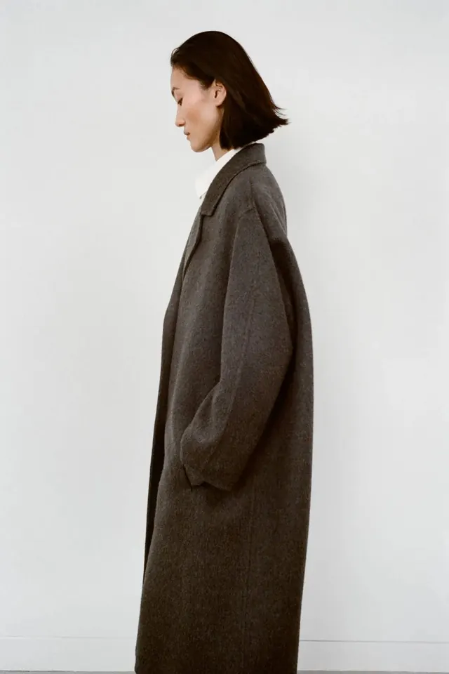 Woman in Oversized Textured Coat, minimal, photographic, muted