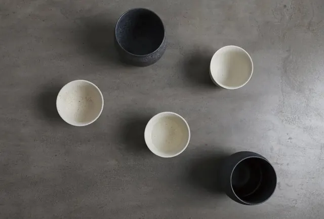Minimalist Ceramic Vessels on Stone Surface, minimal, photographic, muted