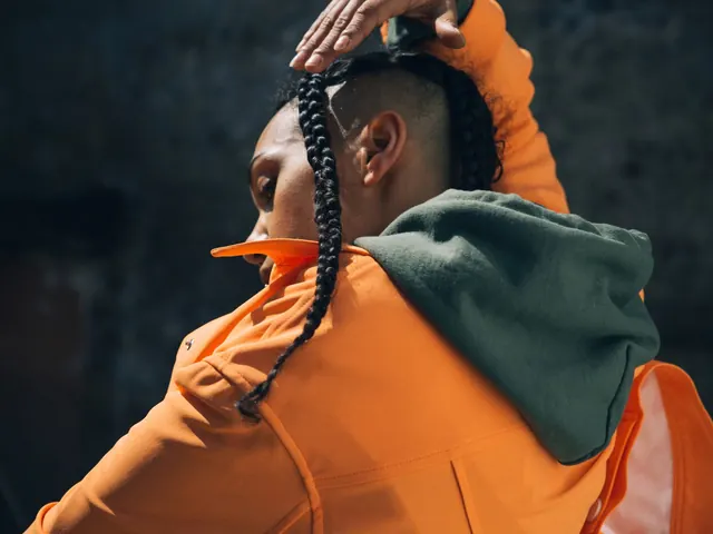 Person in Orange Hoodie and Green Scarf, photographic, organic, vibrant