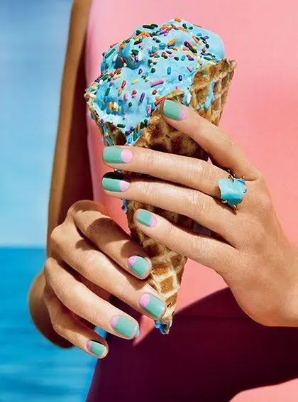 Hand Holding Blue Sprinkled Ice Cream Cone, photographic, playful, vibrant
