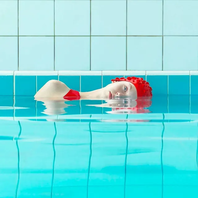 Red and White Swim Cap in Pool, minimal, photographic, vibrant