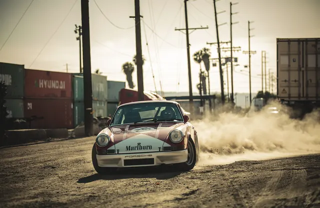 Drifting Car in Industrial Setting, photographic, high-contrast