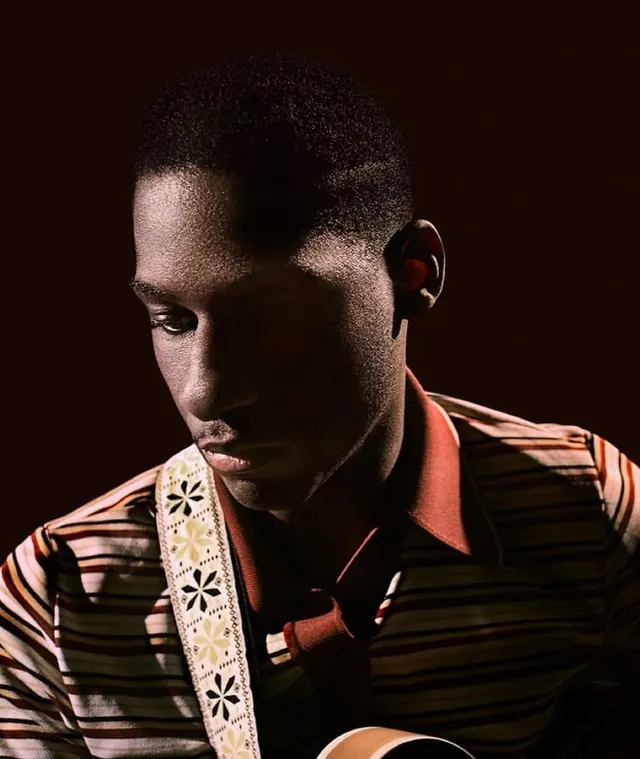 Portrait of a Man in Striped Shirt, photographic, dark-mode, dark