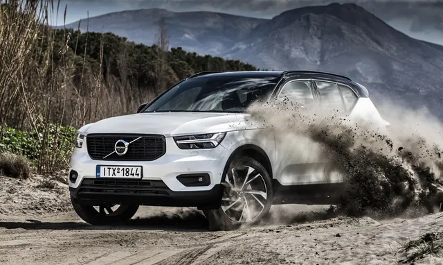 Volvo SUV in Snowy Mountain Landscape, photographic, luxury, high-contrast