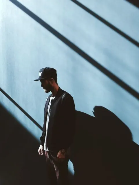 Man in Shadow with Linear Light Patterns, minimal, photographic, dark
