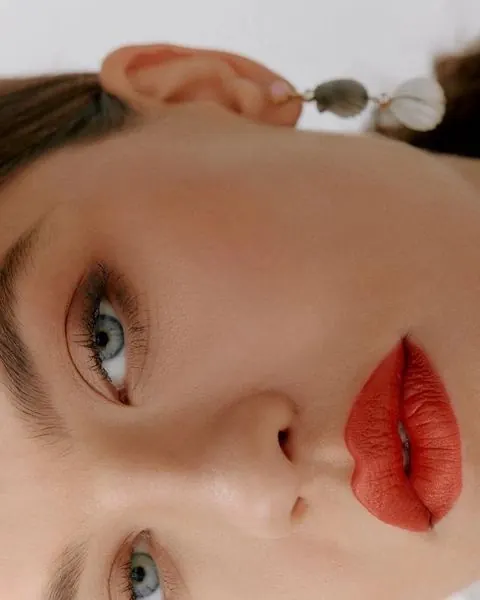 Close-up Portrait of a Woman with Red Lips, photographic, luxury, vibrant