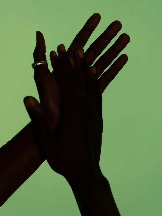 Hand with Ring on Green Background, minimal, photographic, vibrant