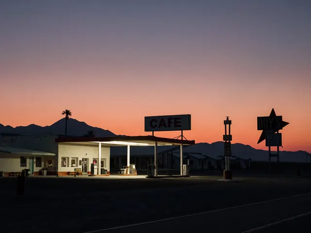 Route 66 diner and motel signage at dusk, photographic, minimal, warm
