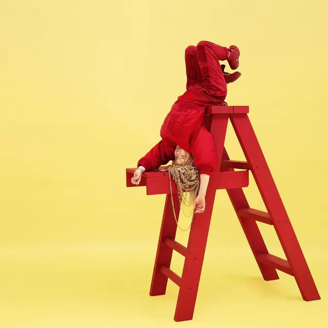 Surreal Red Figure on Ladder, playful, photographic, vibrant