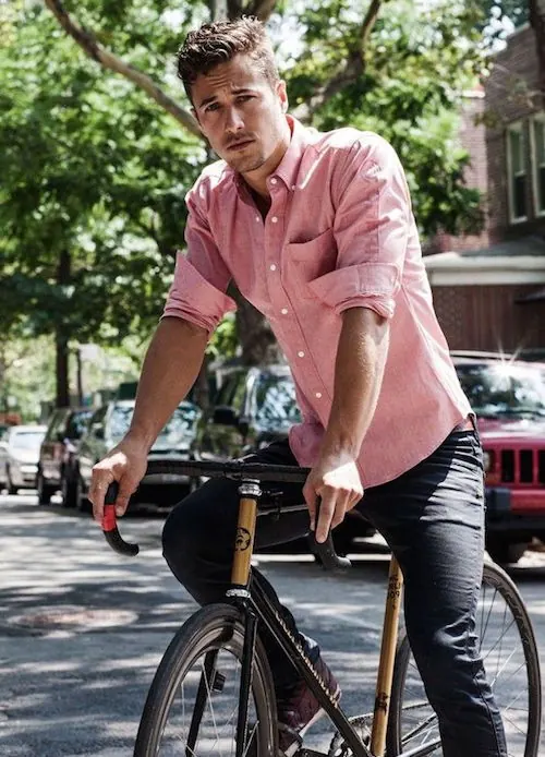 Man in Pink Shirt on Bicycle, photographic, vibrant