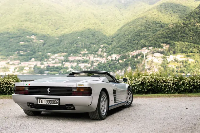 Silver Sports Car in Mountainous Landscape, photographic, luxury, muted