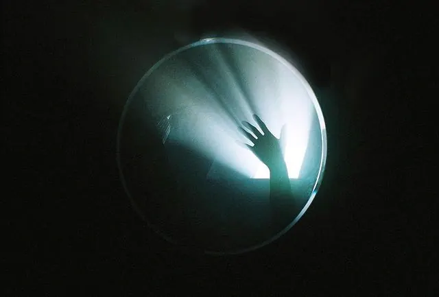 Hand Reaching Through Light, minimal, abstract, dark