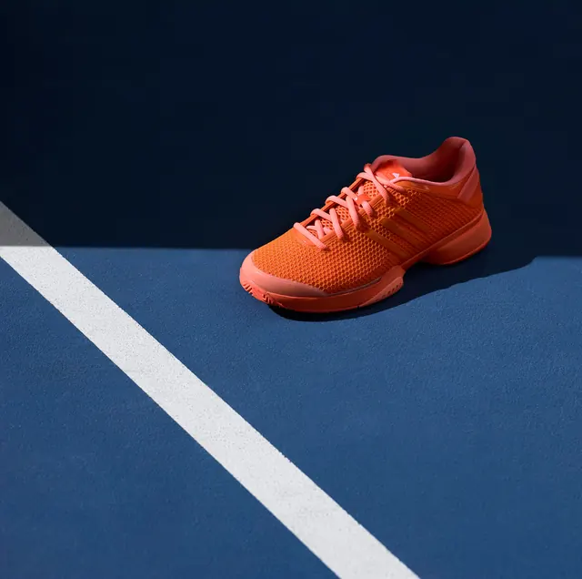 Orange Running Shoe on Track, minimal, photographic, vibrant