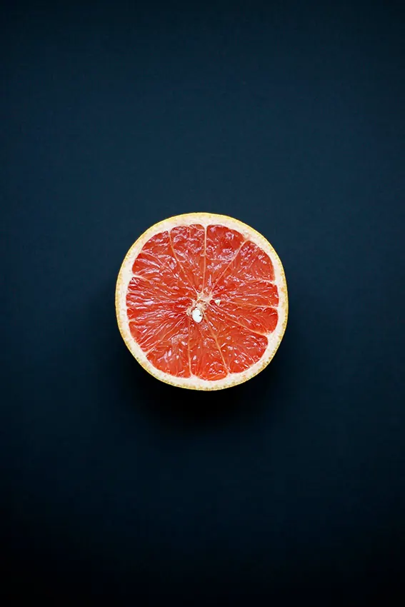 Sliced Citrus Fruit on Dark Background, minimal, photographic, dark